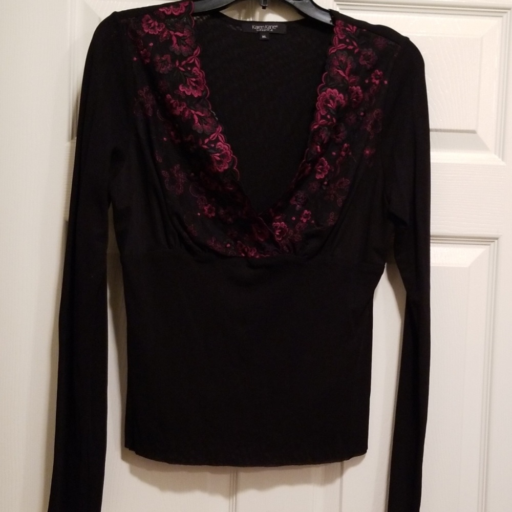 Black blouse with red lace flowers around the neck